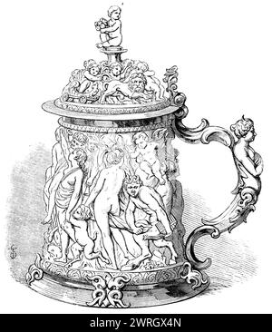 The Loan Collection, South-Kensington, 1862. 'Tankard, mounted in silver-gilt, the drum richly carved with a mythological subject, the Marriage of Jupiter and Juno, &amp;c.: on the cover, which is in ivory, a beautiful frieze of amorini, &amp;c. An exquisitely-finished Flemish tankard, circa 1650...Robert Napier, Esq.'. From &quot;Illustrated London News&quot;, 1862. Stock Photo