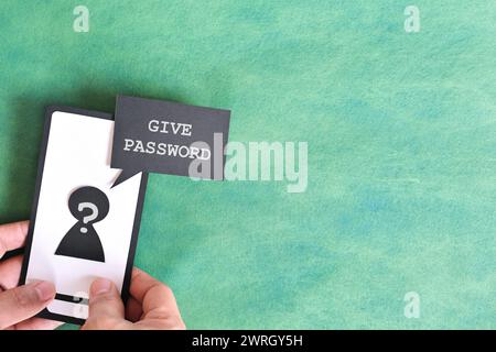 Send password text message smishing scam concept. Hand holding mobile phone with message from unknown sender. Stock Photo
