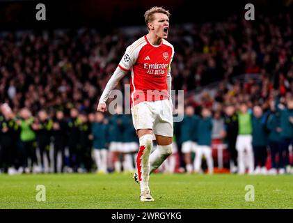 Arsenal's Martin Odegaard celebrates after scoring the first penalty of the penalty shoot-out during the UEFA Champions League Round of 16, second leg match at the Emirates Stadium, London. Picture date: Tuesday March 12, 2024. Stock Photo