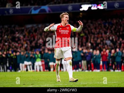 Arsenal's Martin Odegaard celebrates after scoring the first penalty of the penalty shoot-out during the UEFA Champions League Round of 16, second leg match at the Emirates Stadium, London. Picture date: Tuesday March 12, 2024. Stock Photo