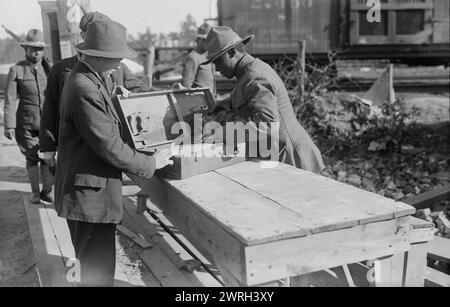 Yaphank, examining packages, 11 Sept 1917 (date created or published later). African American soldier examining a package at Camp Upton, a U.S. Army installation located on Long Island, in Yaphank, New York, during World War I. Stock Photo