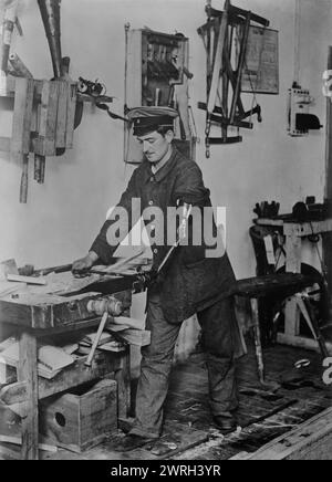 Maimed German at work, between c1915 and 1918. A German disabled soldier with a prosthetic arm working as a carpenter in a workshop in Hindenburg's house at Konigsberg, Prussia (now Kaliningrad, Russia) during World War I. Stock Photo