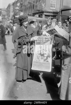 Mrs. J.F. Curtis, Oct 1917. Mrs. James F. Curtis, (the former Laura Beatrice Merriam) wife of James F. Curtis, an Assistant Secretary at the Treasury Department; holding a poster for the 2nd Liberty Loan of 1917 during World War I. Behind her to the right is an Italian American woman who had three sons fighting in Europe. Stock Photo