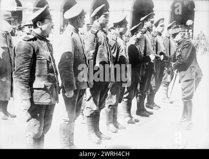 Gen. Cousin decorating Russians, 1915. Similar Agence Meurisse image with French caption: &quot;Le ge&#xb4;ne&#xb4;ral Cousin de&#xb4;core des prisonniers russes aux Invalides&quot;, publication date 1915. Translation: General Cousin decorates the Russian prisoners at the Invalides. Stock Photo