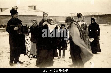 Mummers on the streets of the Znamensky Glass Factory on Christmastide, 1913-1914. From a collection which  includes more than four hundred photographs of daily life in Yenisei Province in the late tsarist period. Photographs include peasants, Cossacks, and high-ranking officials. Krasnoiarsk Krai Museum of Regional History and Folklife Stock Photo