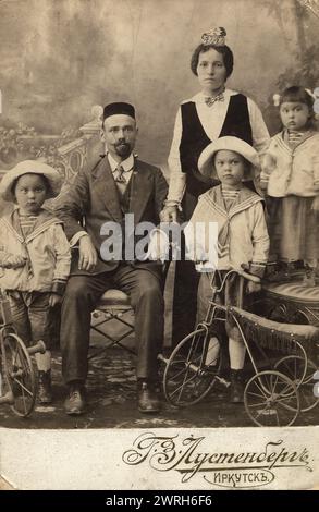 Tatar family of an employee of the office of Irkutsk merchants Shafigulins G.M. Muratov - wife Faizoy and children Anvar Bek, Hamid and Galchira, 1915. From a collection of 136 photographs of Irkutsk from the late nineteenth and early twentieth centuries. The photographs show views of both the city of Irkutsk and countryside of Irkutsk Province; methods of transportation; and the citizenry, including their way of life, social activities, and forms of entertainment. Irkutsk Municipal History Museum Stock Photo