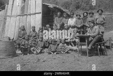 Inhabitants of One Gornaia Shoria Village and an Expedition Member; making a List of All Home Owners, 1913. From a collection of 109 photographs taken during a 1913 topographic expedition to the Gornaia Shoria in the Altai region and another topographic expedition to the Mrasskii region, Kuznetskii District (central part of the Gornaia Shoria). The photographs reflect both expedition activities and the life of the people in this region. Altai State Regional Studies Museum Stock Photo