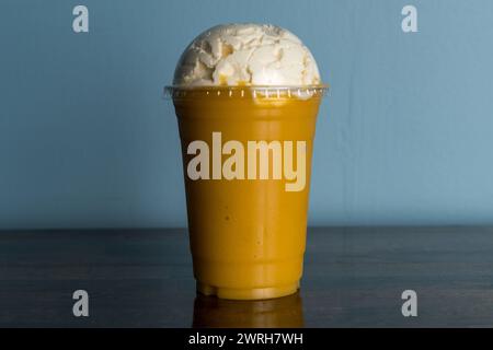 Mango-banana smoothie with whipped cream Stock Photo