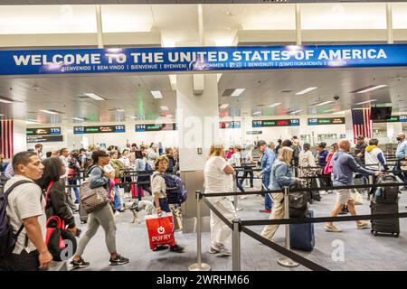 Miami Florida,Miami International Airport MIA,inside interior terminal,passport control,overhead sign signs information,promoting promotion advertisin Stock Photo