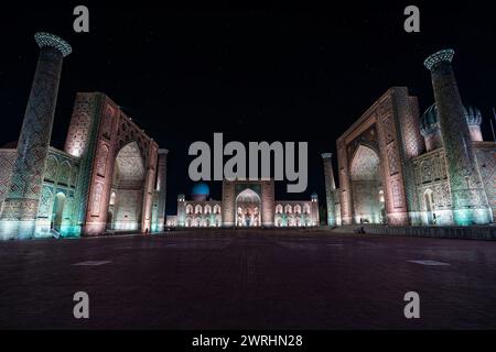 Registan Square at Night with Stars, an old public square with starry sky in heart of the ancient city of Samarkand, Uzbekistan. Translation: May God' Stock Photo