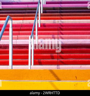 Colourful stairs up along Las Vegas Boulevard - rainbow colored striped steps on the strip with silver handrail - colorful urban staircase street art Stock Photo