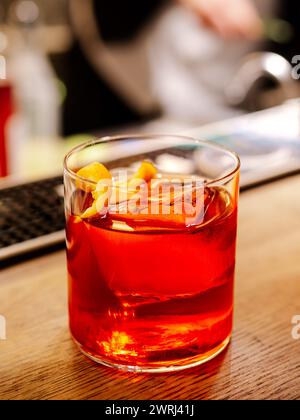 Negroni cocktail on bar counter. Negroni classic cocktail and gin short drink with sweet vermouth, red bitter liqueur Stock Photo