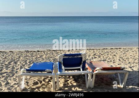 Two sun loungers with towels on the empty beach overlooking the sea, Trinidad, Cuba, Central America Stock Photo