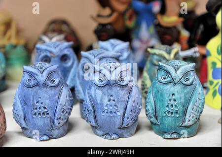 Blue and green ceramic owl figurines arranged on a table, Trinidad, Cuba, Central America Stock Photo