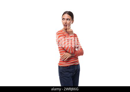 caucasian smart young black-haired woman with a ponytail hairstyle dressed in an orange jacket on a white background Stock Photo