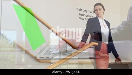 Image of hands working on laptop with green screen over businesswoman on staircase at workplace Stock Photo