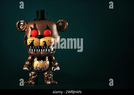 Funko POP vinyl figure of Nightmare Freddy character of the videogames,movies and books Five Nights at Freddy's over green background. Illustrative ed Stock Photo