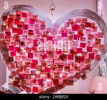 Sibiu City, Romania - 05 March 2024. Colorful sticky notes with various love messages Romanian language stuck on the window Stock Photo
