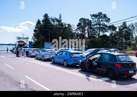 CARS QUEUE, SVINÖ HARBOUR, FÖGLÖ FERRY: Queue of Cars at Ferry Port Harbour of Svinö, the departure point to travel to Föglö in the Åland Islands in Baltic Sea, Finland. Föglö is a rural island in the Åland archipelago in Finland. It is known for its rolling hills, forests, and fertile farmland, as well as its traditional wooden architecture and charming villages Stock Photo