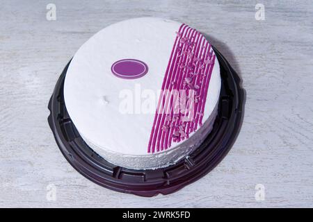 Festive sponge fruit cake with lilac and white cream. View from above. Stock Photo
