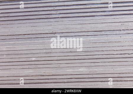 Close up shot of many stacked grey artificial sheets of plywood for construction works or interior decoration. Stock Photo