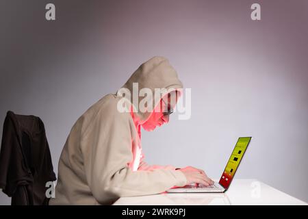 Older criminal man using computer for remote money robbery Stock Photo