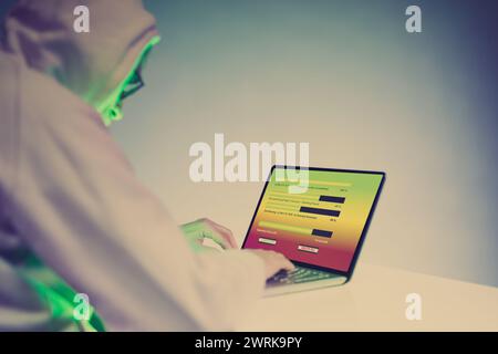 Older criminal man using computer for remote money robbery Stock Photo