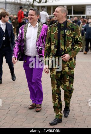 Racegoers Ash Robinson (left) and Paul Norfolk wearing colourful suits on day two of the 2024 Cheltenham Festival at Cheltenham Racecourse. Picture date: Wednesday March 13, 2024. Stock Photo