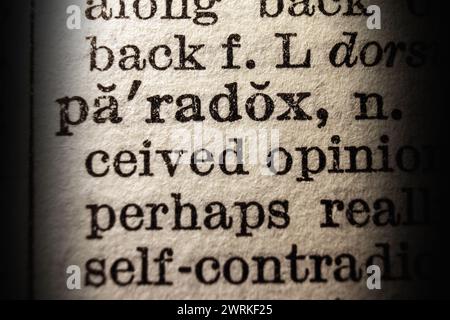 Word paradox on dictionary page, macro close-up Stock Photo