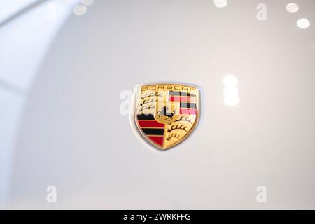 black Porsche Taycan GTS Sport Turismo battery-electric sports Car, Logo on cap, Porsche Automobil Holding in showroom, Innovation in automotive indus Stock Photo