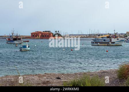 Boats in harbour of Marzamemi village on the island of Sicily, Italy. View with Brancati Islet Stock Photo