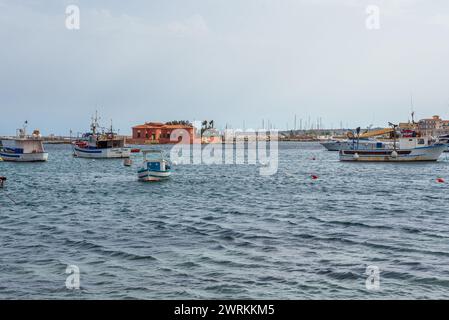 Boats in harbour of Marzamemi village on the island of Sicily, Italy. View with Brancati Islet Stock Photo