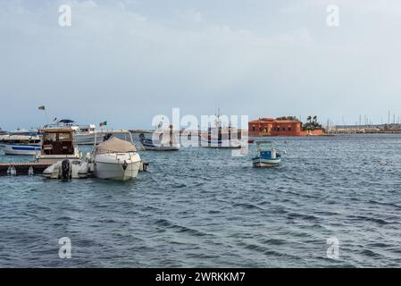 Boats in harbour of Marzamemi village on the island of Sicily, Italy. View with Brancati Islet Stock Photo