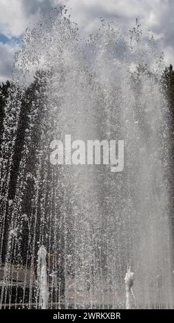 White water fountain in lighted pool at night Stock Photo - Alamy