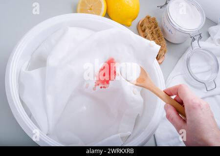 Homemade eco-friendly removing of stains on clothes with baking soda. Natural cleaning products. daily life stain concept. top view. Stock Photo