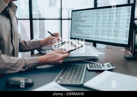 Investors working on desk office and use tablet to  check tracking cost. Accounting and  Financial concept. Stock Photo