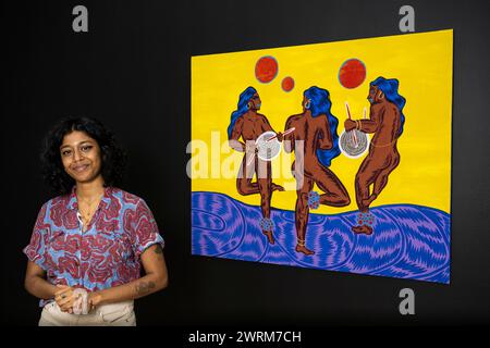 Nottingham, UK.  13 March 2024.  Multidisciplinary South Indian artist Osheen Siva with an Untitled work at their first UK exhibition ‘Karuppu’ (darkness/black in Tamil).  Siva’s work critiques Hindu scriptures and ancient Sanskrit texts that continue the discrimination of lower-caste individuals, particularly Dalits who are among India’s most marginalised citizens.  The works are on show at Bonington Gallery, Nottingham Trent University, 16 March to 4 May 2024.  Credit: Stephen Chung / Alamy Live News Stock Photo