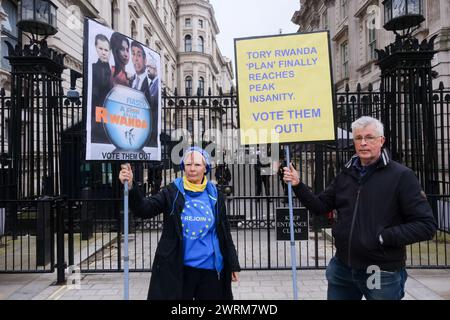 Downing Street, London, UK. 13th Mar 2024. Two protesters with anti Rwanda Plan protesters outside Downng Street. Credit: Matthew Chattle/Alamy Live News Stock Photo