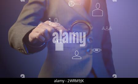 Cg tech collage. A female hand holds a magnifying glass against the background of a silhouette in a business suit with symbols of digitalization of co Stock Photo