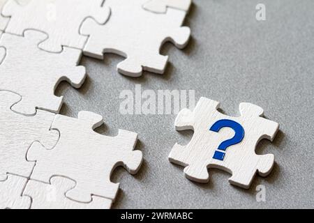 Puzzle piece with question mark, missing piece, business concept Stock Photo