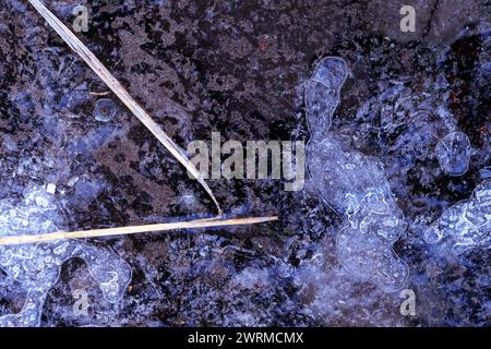 Close-up of intricate frozen water with air bubbles and natural textures Stock Photo