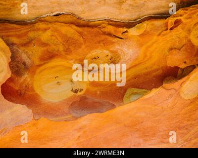 The richly hued rock formations of Jaizkibel's coloured cliffs in Gipuzkoa, Spain, showcasing swirling patterns and natural beauty. Stock Photo