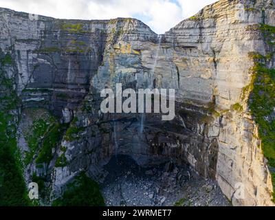 A breathtaking aerial view of the Salto del Nervion waterfall, showcasing its towering cliffs and lush vegetation in Alava, Spain. Stock Photo