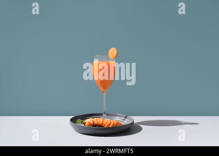 An exquisite arrangement featuring a refreshing cocktail garnished with a slice of citrus and smoked salmon delicately placed on a sleek black plate, Stock Photo