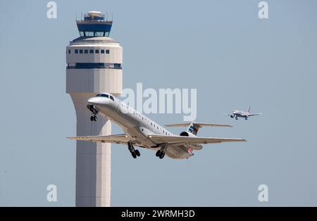 CHARLOTTE, NC (USA) - June 14, 2019:  An American Eagle passenger airliner takes off from Charlotte-Douglas International Airport with a second airlin Stock Photo