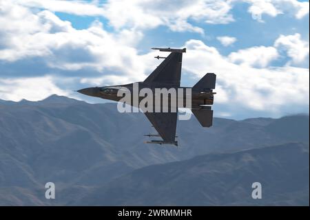 An F-16C Fighting Falcon assigned to the 706th Aggressor Squadron (AGRS), conducts a familiarization flight for over a low-level training area Stock Photo