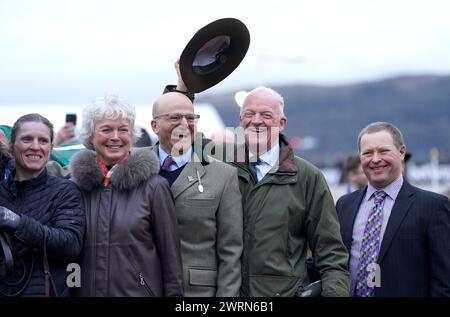 Trainer Willie Mullins celebrates his 100th Cheltenham Festival victory with wife Jackie Mullins and the winning connections after Jasmin De Vaux won the Weatherbys Champion Bumper on day two of the 2024 Cheltenham Festival at Cheltenham Racecourse. Picture date: Wednesday March 13, 2024. Stock Photo