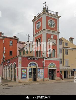 Rovinj, Croatia - October 15, 2014: Compass Travel Agency and Clock Bell Tower at Town Square. Stock Photo
