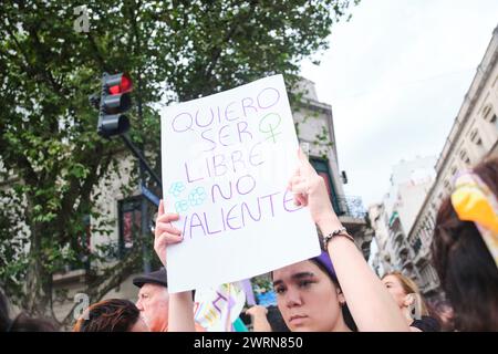 Buenos Aires, Argentina; March 8, 2024: International feminist strike. Young woman holding up a poster: I want to be free, not brave. Stock Photo