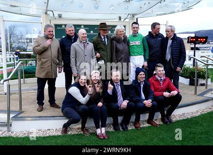 Trainer Willie Mullins, wife Jackie Mullins, jockey Patrick Mullins, Ruby Walsh and their connections pose for a photo as they celebrate after Jasmin De Vaux wins the Weatherbys Champion Bumper on day two of the 2024 Cheltenham Festival at Cheltenham Racecourse. Willie Mullins reached the magical 100-winner mark at the Cheltenham Festival as the Patrick Mullins-ridden Jasmin De Vaux provided him with a 13th victory in the Weatherbys Champion Bumper. Picture date: Wednesday March 13, 2024. Stock Photo